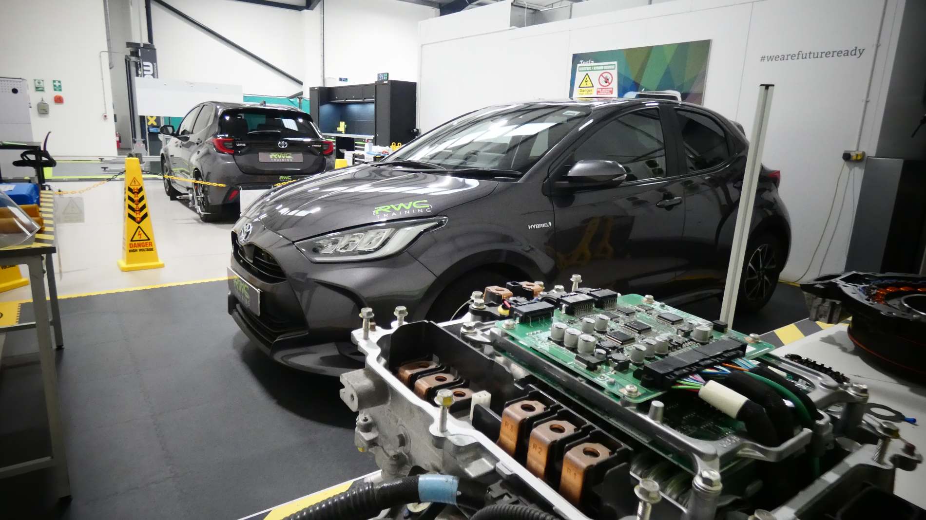 EV repair bay with hybrid car