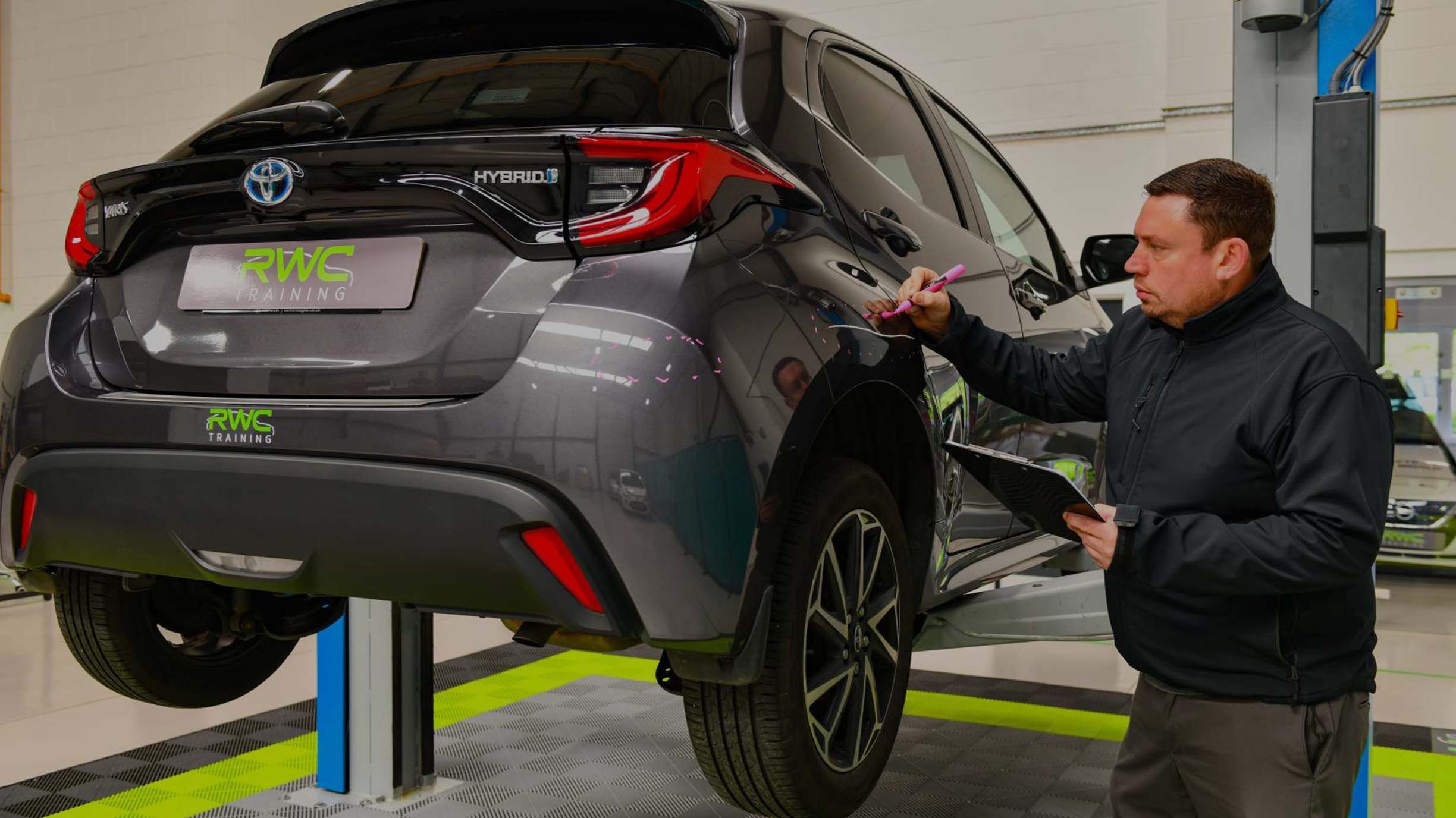 VDA 4 Assessor checking a grey car to see what damage their is